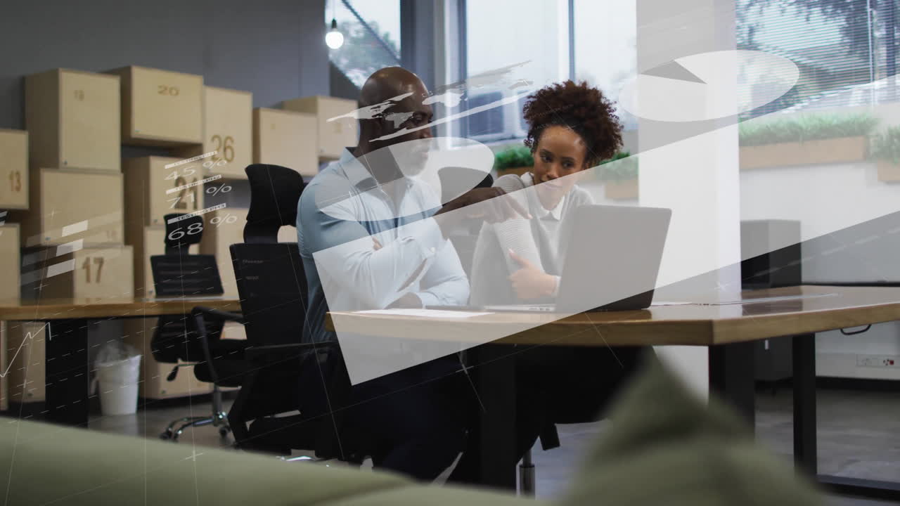Discussing data, business professionals with financial animation overlay in modern office
