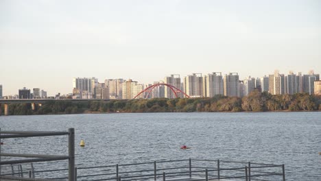 A tranquil river view from Yeouinaru Station Wharf in Yeouido-dong, Seoul, South Korea, surrounded by urban charm.
