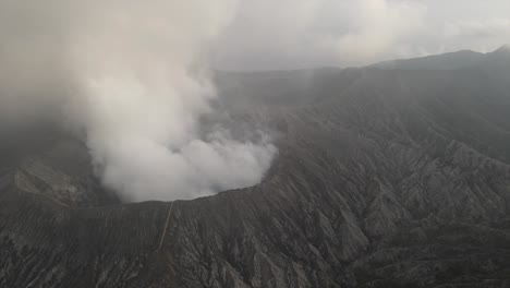 bromo volcano steaming crater east java indonesia rugged terrain drone aerial landscape