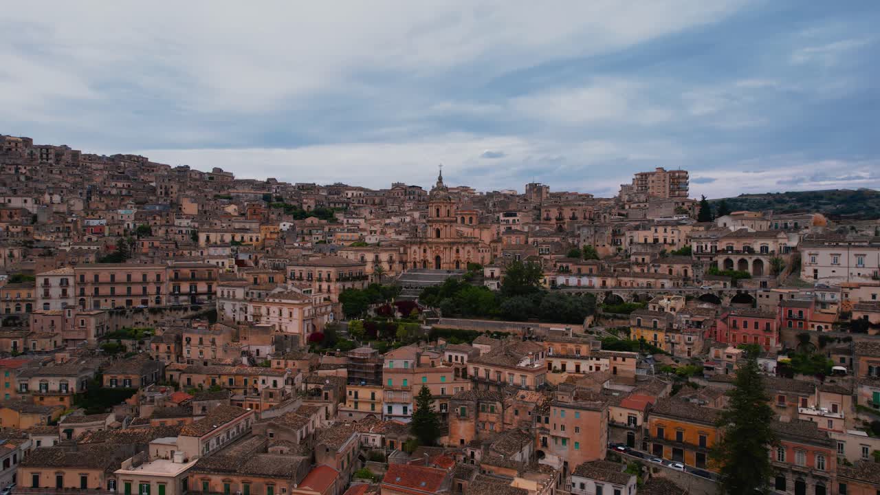 Modica, near Ragusa, Sicily, Italy. Aerial view of cathedral, church, piazza, rooftops, and old town