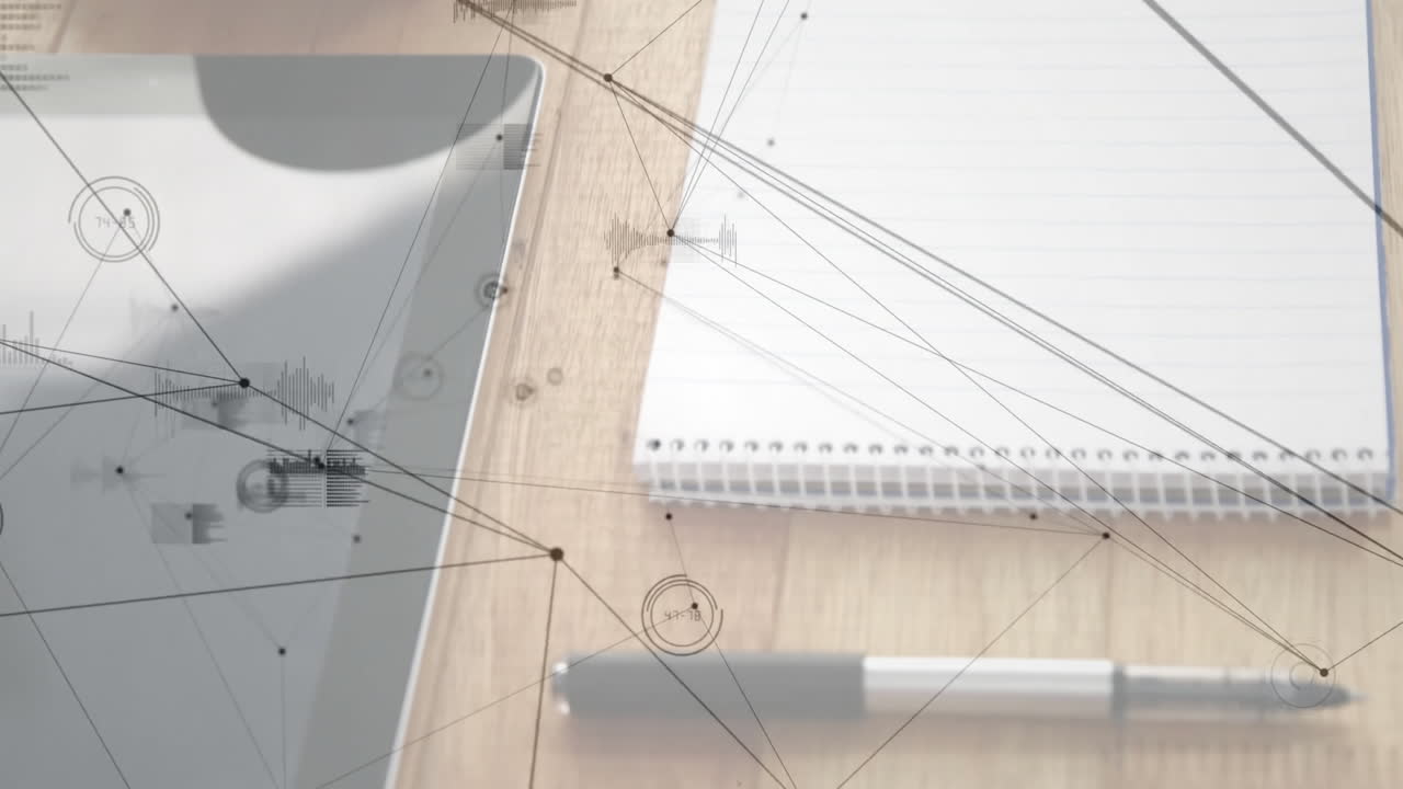Gray tablet occupying left, notebook and pen lying right, network graphics floating above desk