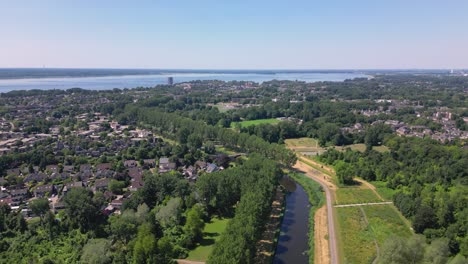 aerial drone shot above the sity of almere haven with a gooilake on background, province flevoland, netherlands