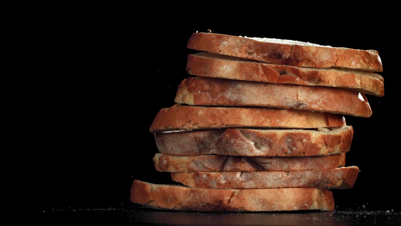 Fresh Bread Slices Falling and Stacking in Slow Motion