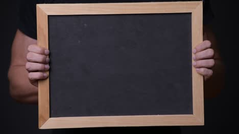 hand holding empty blackboard