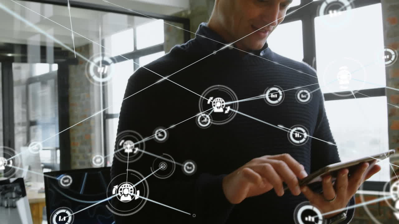 Network of digital icons against caucasian businessman using digital tablet at office