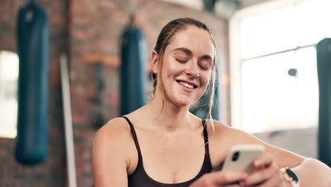 woman in gym using smartphone