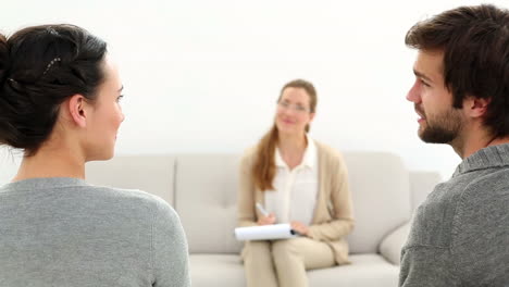 therapist smiling at reconciled couple