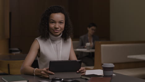 woman working on tablet in a coffee shop