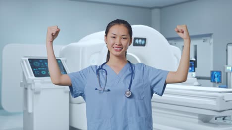 asian female doctor smile and flex muscle with mri machine