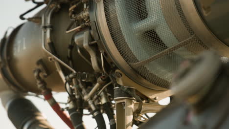 The engine of a gazelle helicopter is being thoroughly inspected. Close-up views highlight various components and intricate details of the engine in a clear and informative manner.