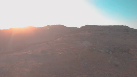 Drone-flying-down-over-mountains