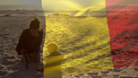 animation of flag of belgium over happy caucasian mother with child playing at beach