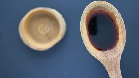 wooden spoon with dark liquid