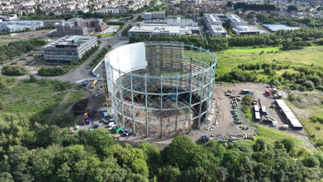 4K-Close-Up-Slow-Aerial-of-Granton-Gasholder-under-construction,-Edinburgh,-The-Capital-of-Scotland,-United-Kingdom