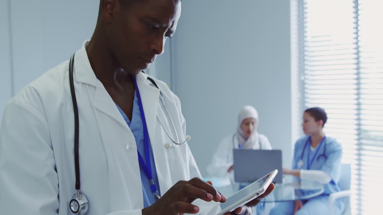 Close-up of African American male doctor using digital tablet in hospital