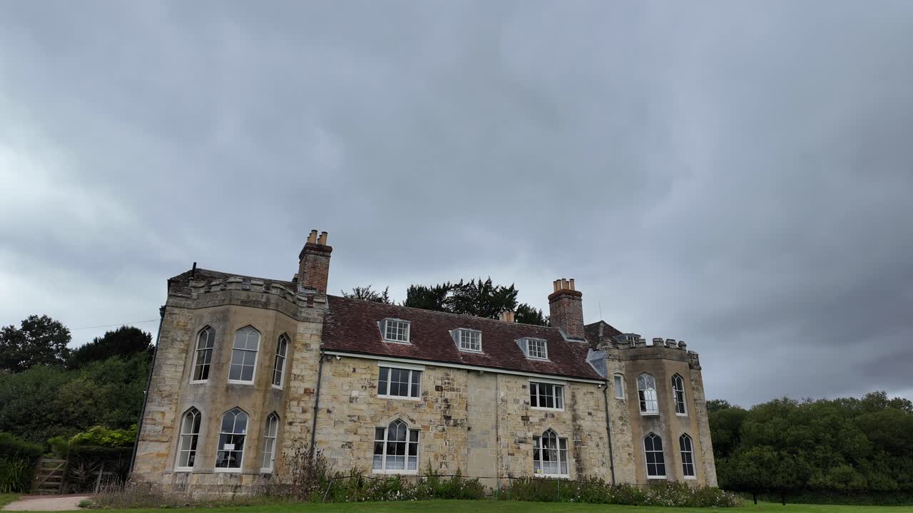 drone shot of the Dower House at Old Bayham Abbey, Kent. Historic architecture surrounded by lush countryside, ideal for travel, heritage, or cinematic projects
