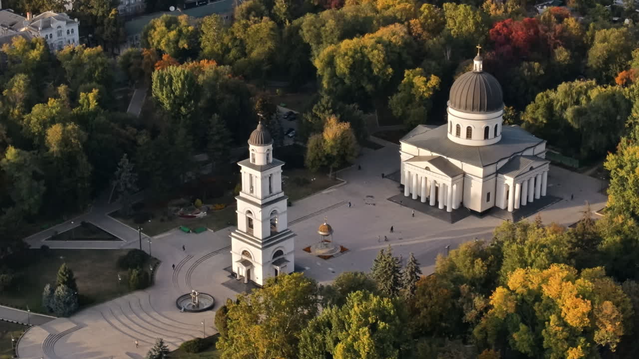 Aerial drone view of Chisinau downtown. View of central park, Cathedral, bell tower, a lot of greenery, walking people. Moldova