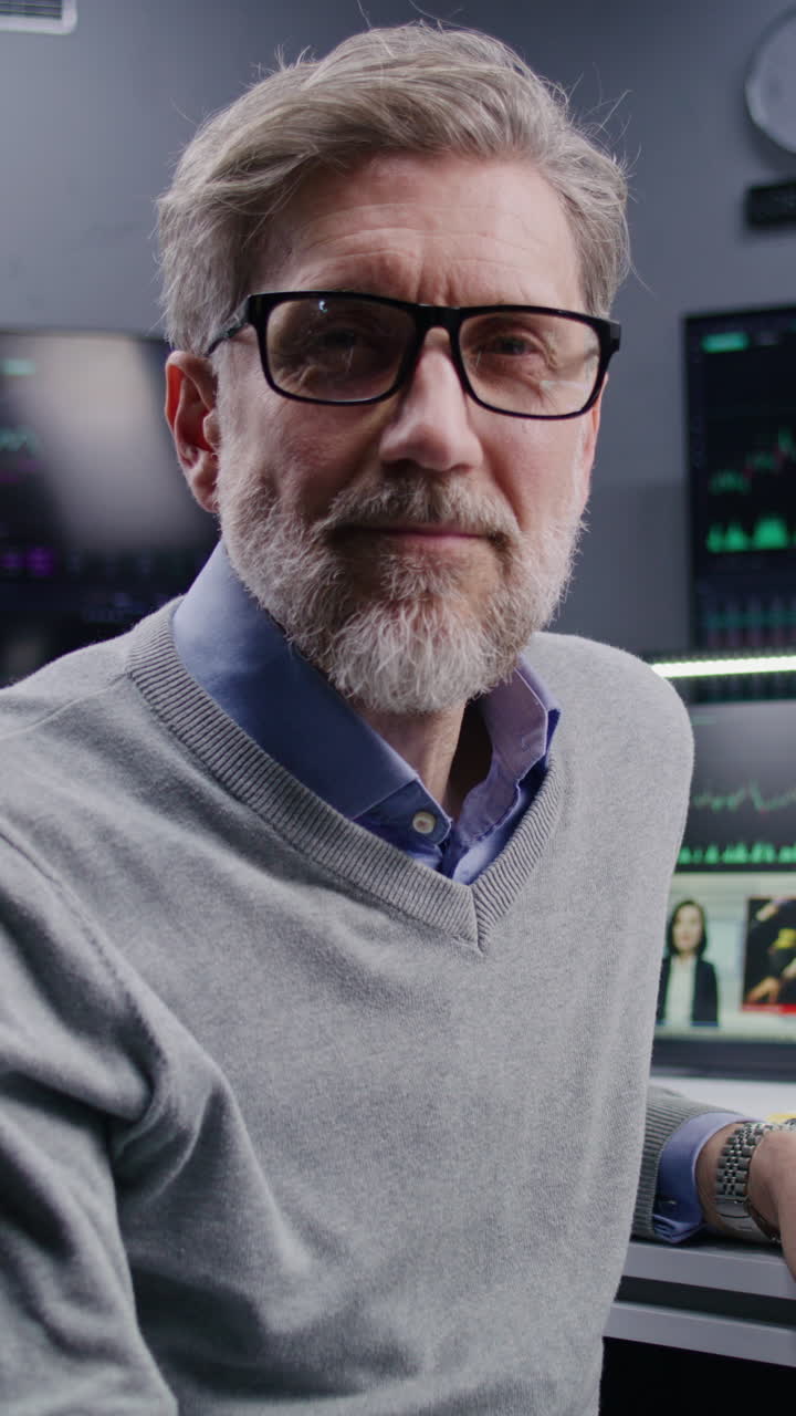 Businessman in office, looking at camera