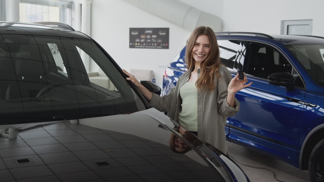 Woman at car dealership happy with new car purchase
