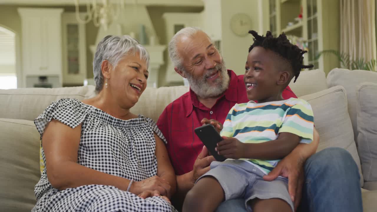 Grandparents and grandson using smartphone at home