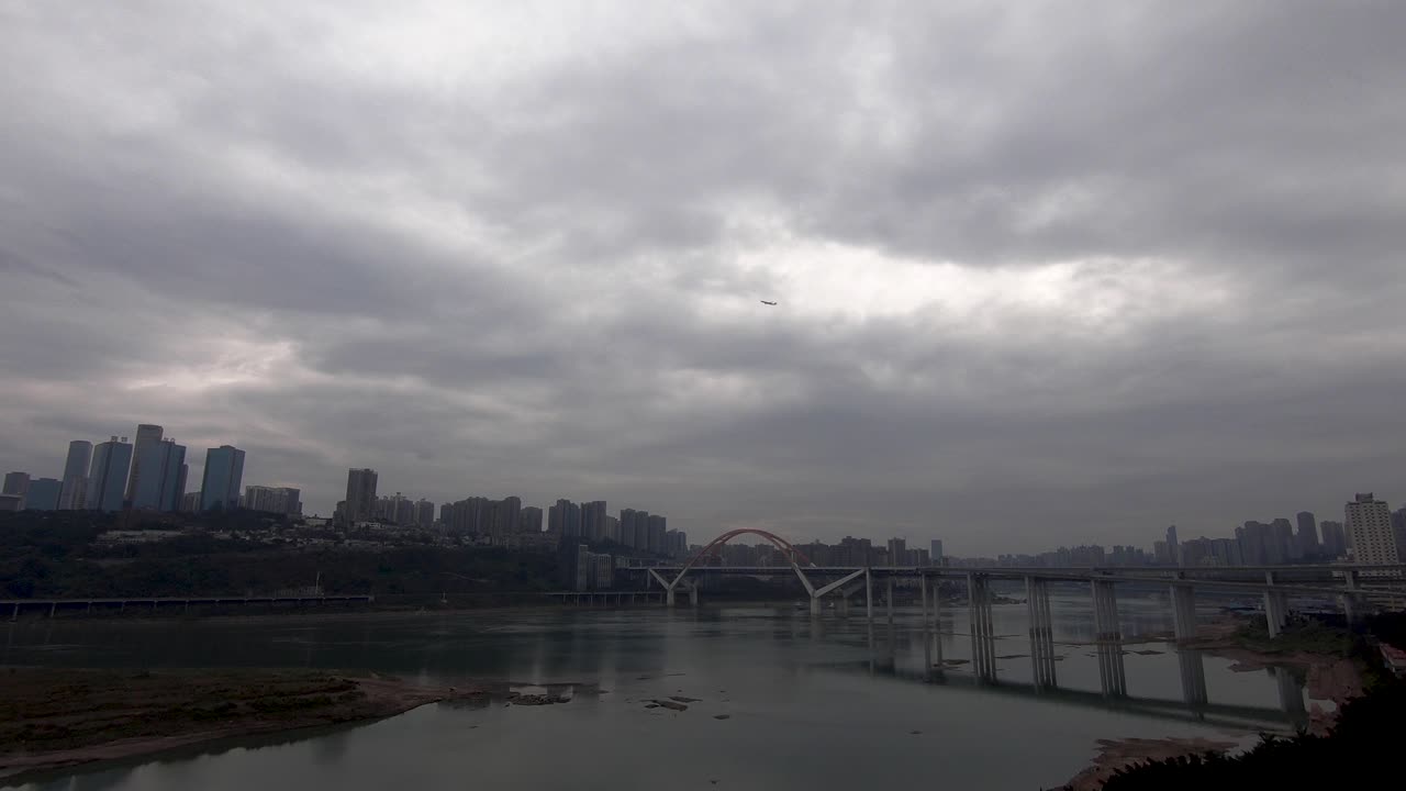 Airplane leaving ChongQing city with river and cityscape in background