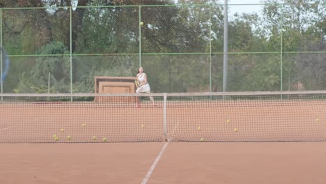 female tennis player practicing serve on outdoor court