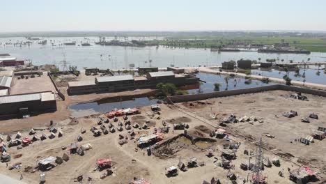 aerial view of makeshift camps for flood disaster victims in maher, sindh with flooded landscape in background