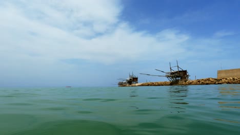 low-angle sea-level pov of trabocchi or trabucchi at punta penna in abruzzo, italy