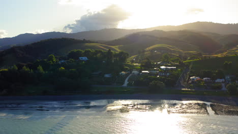 golden hour over a coastal village and hills