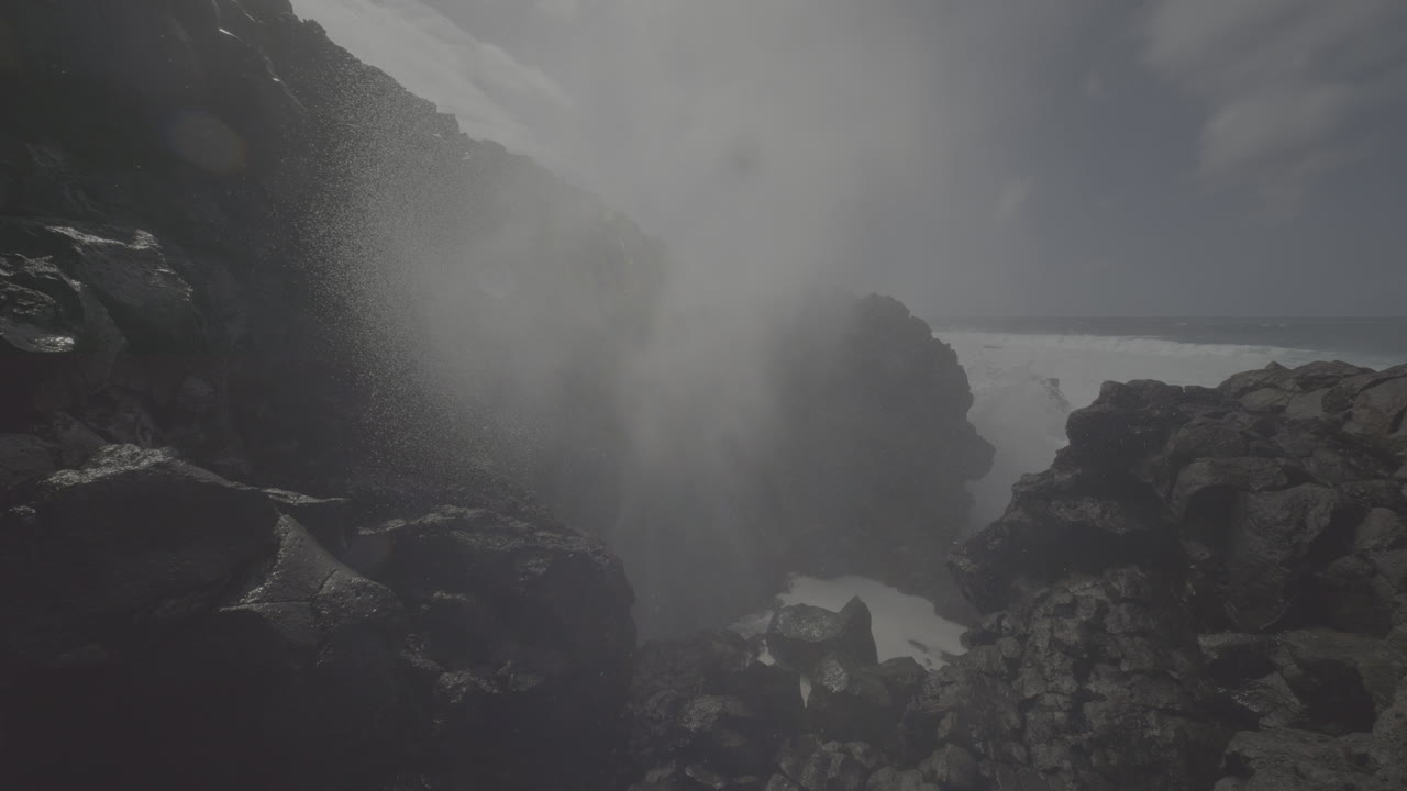 Powerful Waves Crashing Against Volcanic Cliffs