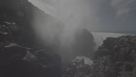 powerful waves crashing against volcanic cliffs