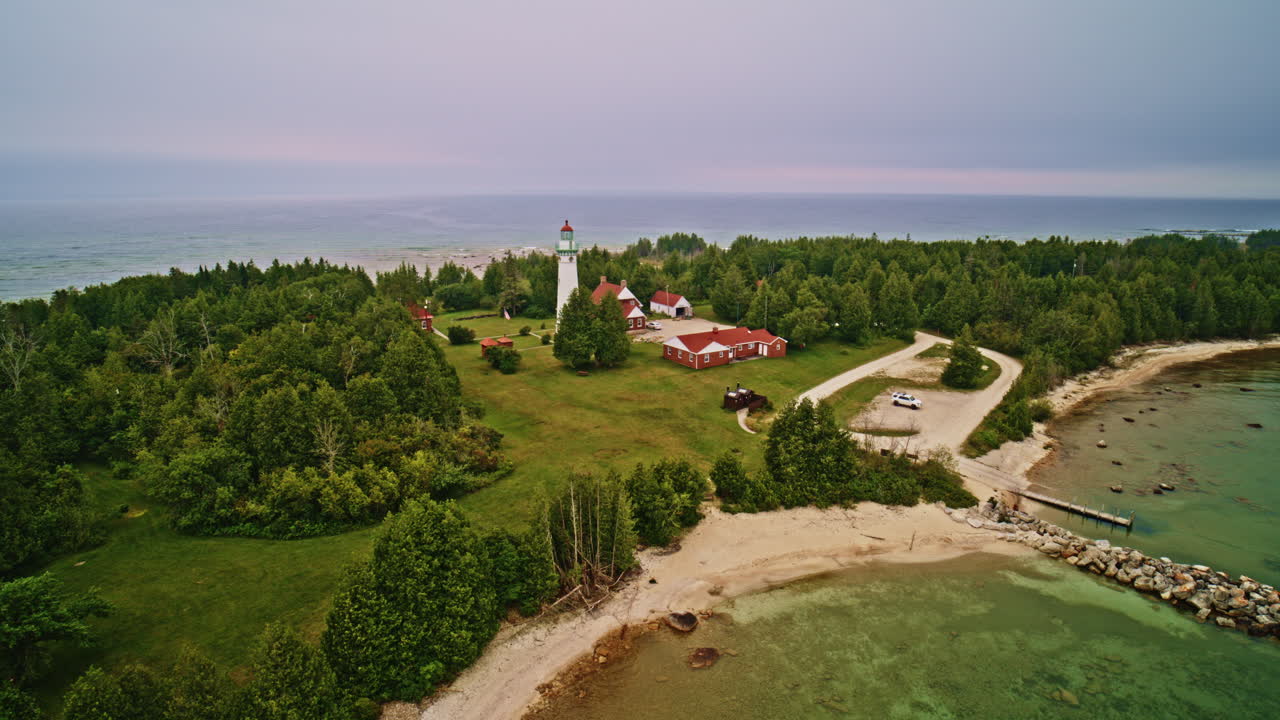 Drone shot panning lighthouse in lake Michigan