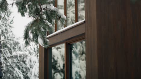 Close-up-of-wooden-house-in-winter-time-inside-of-forest.