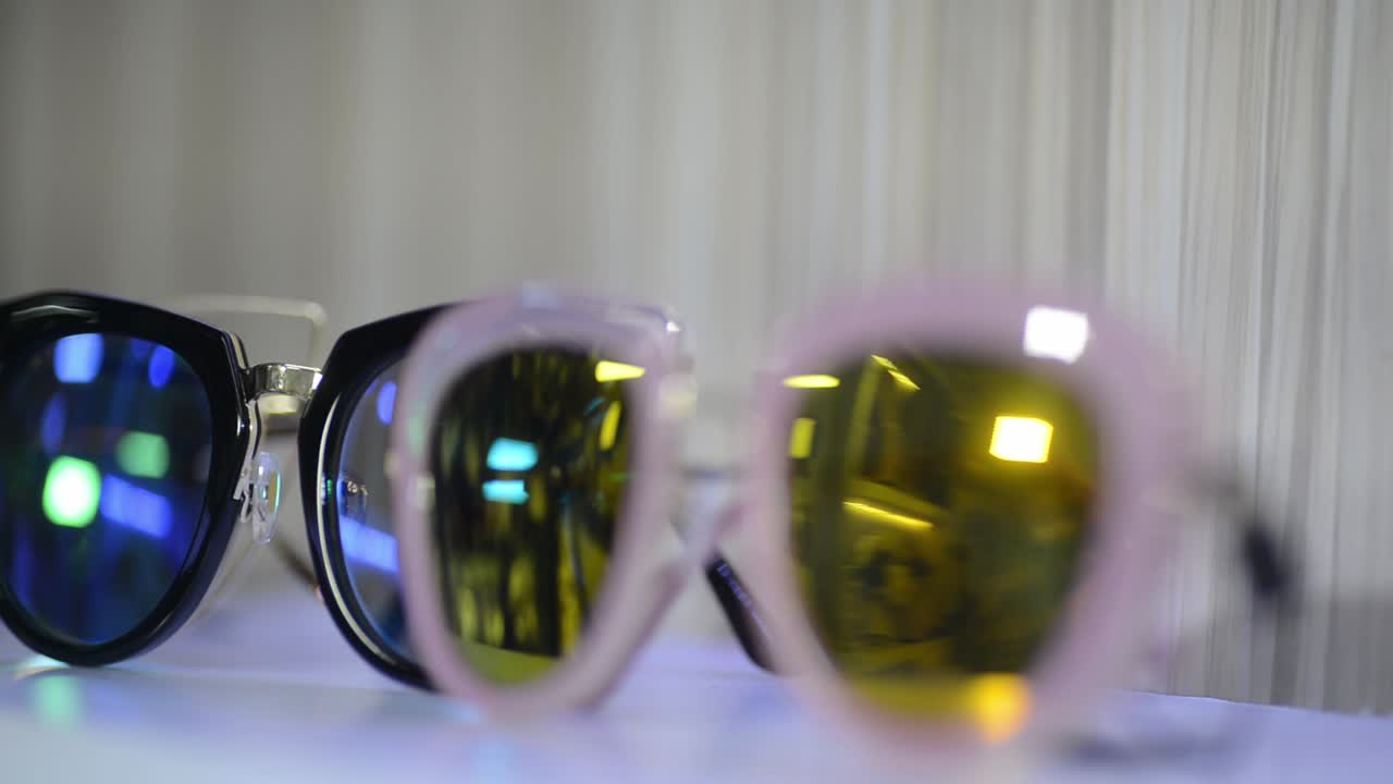 Sunglasses for sale in shop storefront, closeup rack focus