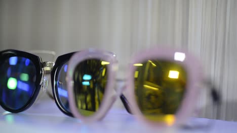 sunglasses for sale in shop storefront, closeup rack focus