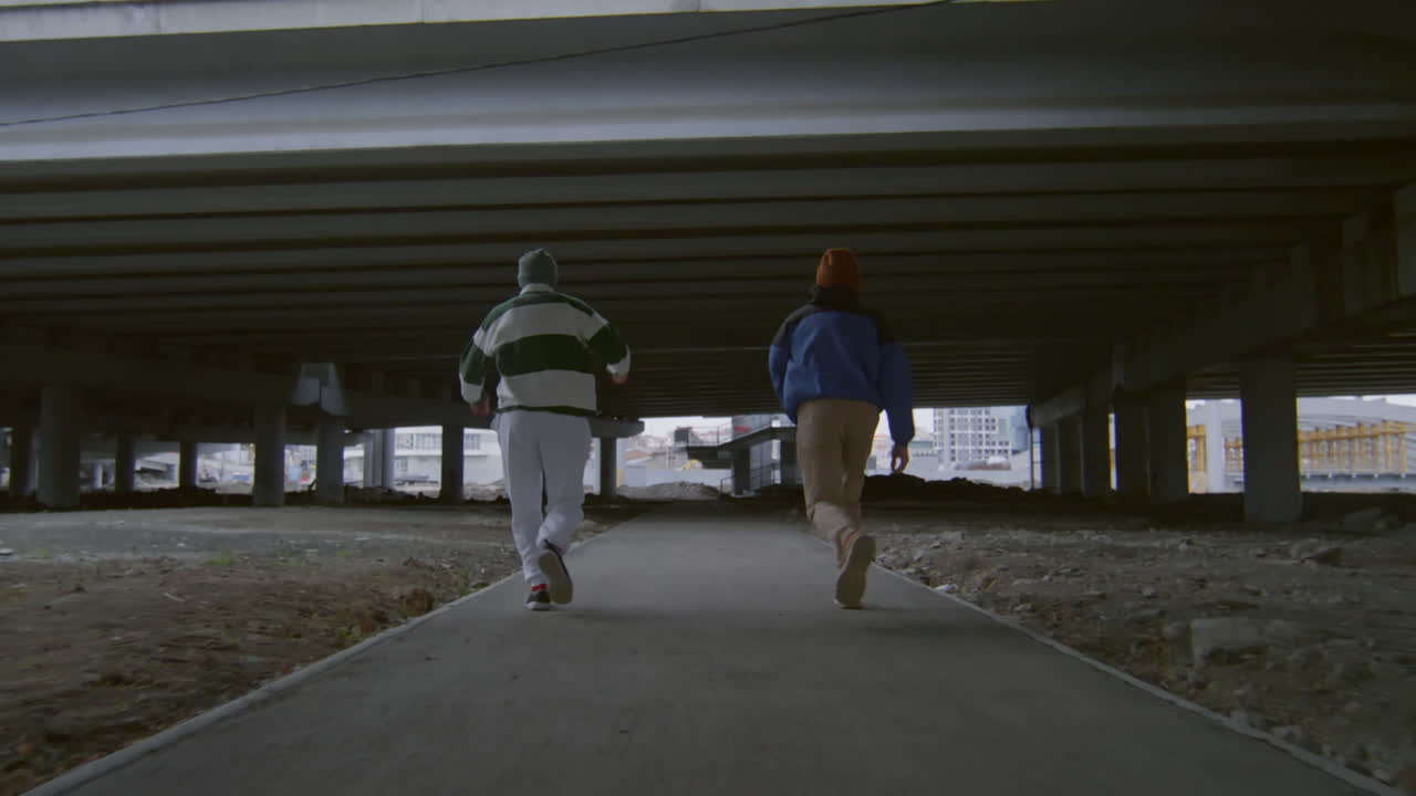 Two Parkourists Running and Doing Side Flips