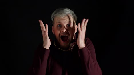 overjoyed young man wins competition achieves goal and makes triumph gesture, says yes, shows fist