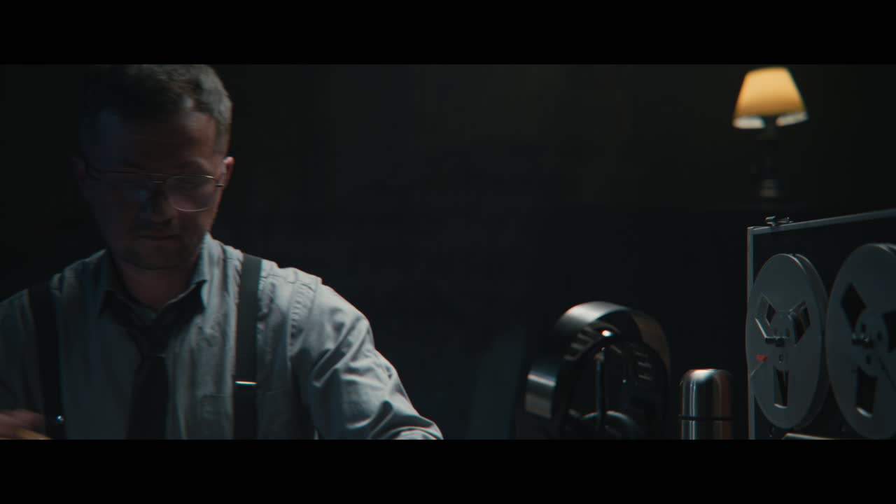 An intelligence officer sits down to the wiretap station