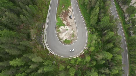 an aerial shot of a mountain road in italy