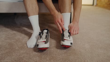 person putting on cycling shoes