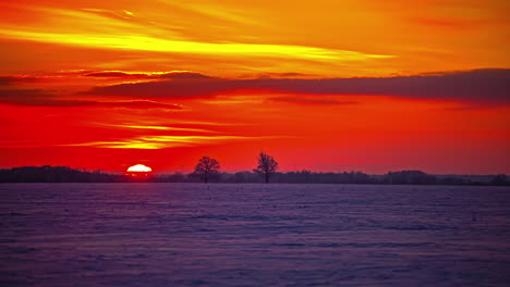 dawn timelapse of red sky turning into orange as sun shines in the sky and crosses