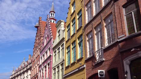 establishing shot of apartments and homes in bruges belgium with cobblestone street 1