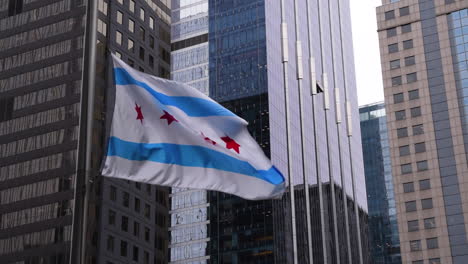 chicago flag waving in the wind of with chicago buidings on the background