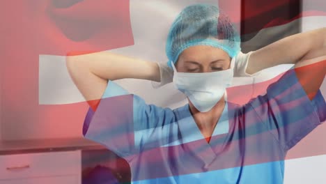 Animation-of-flag-of-switzerland-waving-over-surgeons-in-operating-theatre