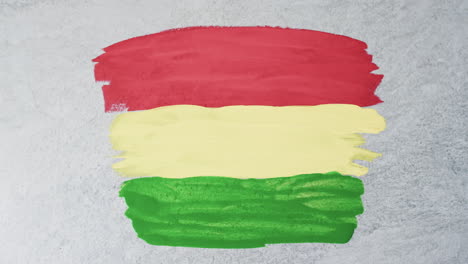 video of red, yellow and green paint smudges with copy space on grey background