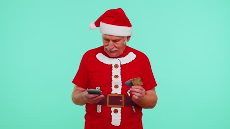 El-Hombre-Mayor-De-Navidad,-Abuelo,-Usa-Tarjetas-Bancarias-De-Crédito-De-Plástico-Para-Teléfonos-Móviles,-Gana-Calebrate,-Guau