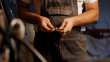 male mechanic checking spanner in garage 4k