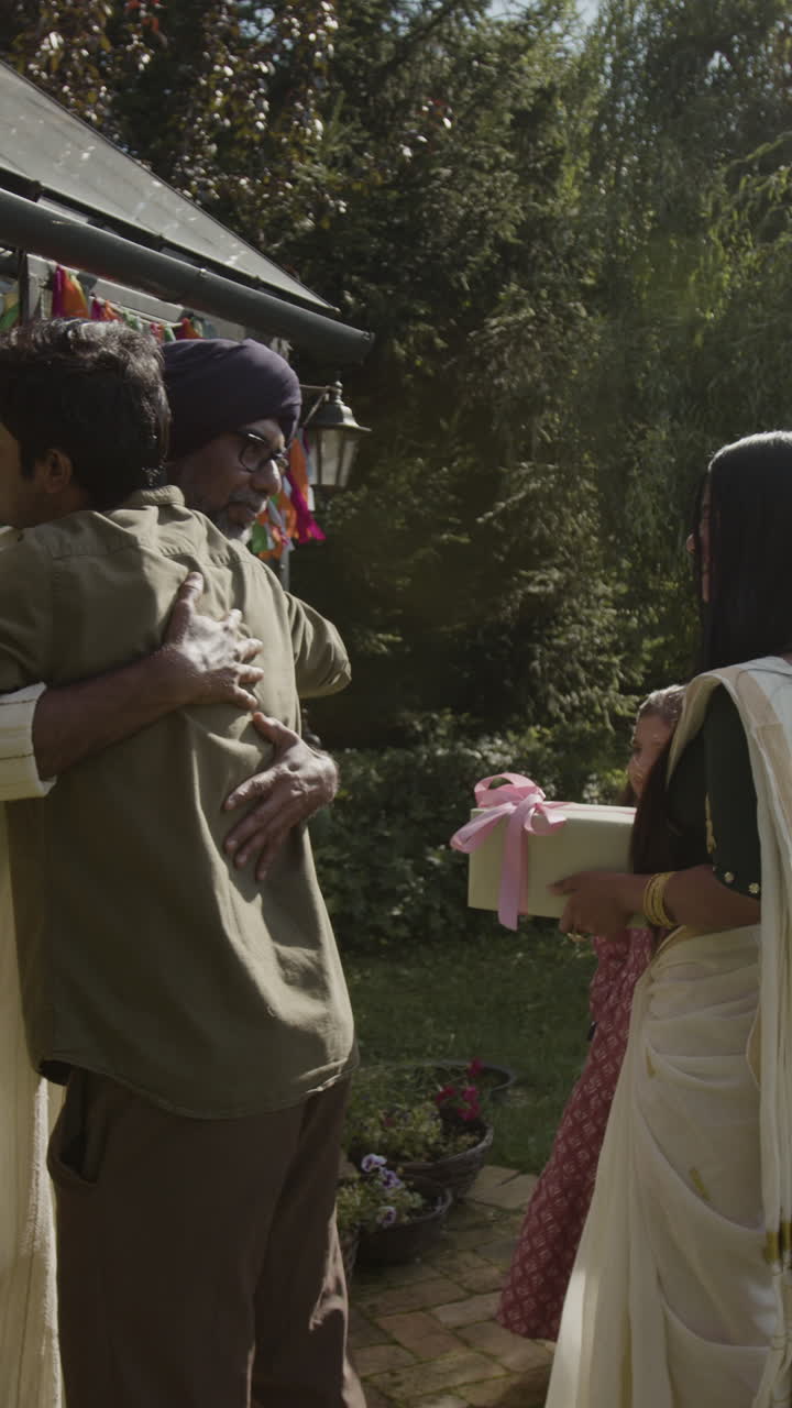 A heartwarming family celebration with gifts and hugs in a festive garden