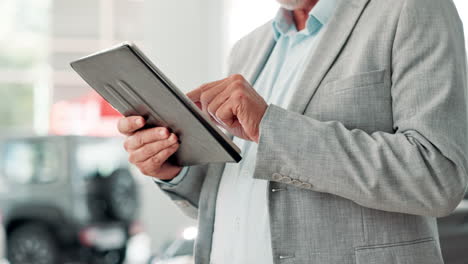 businessman using tablet in car dealership