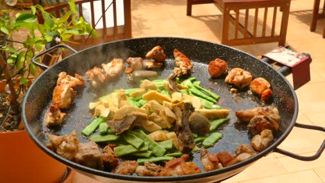 Traditional-paella-preparation-from-the-Valencian-region-with-chicken-and-vegetables